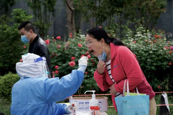 Covid-19: nouvelles restrictions à Pékin, aux airs de ville fantôme